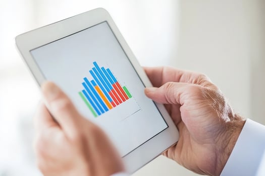 Analyzing data trends on a tablet in a bright office environment during a working day photo