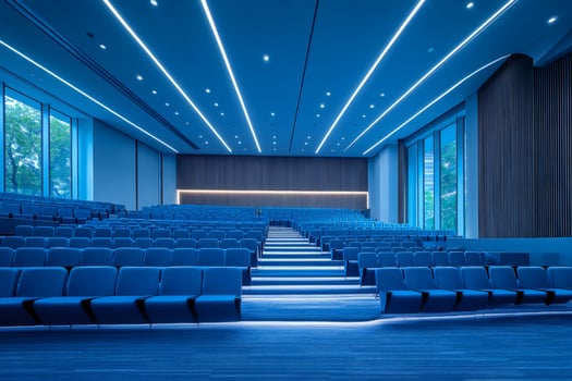 Modern conference hall with blue seats and lighting creating a futuristic atmosphere photo