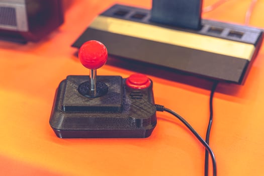 Retro Gaming Joystick and Classic 80s Console Close-Up photo