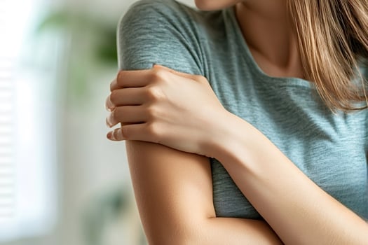 Woman holding her arm suffering from muscle pain or injury photo