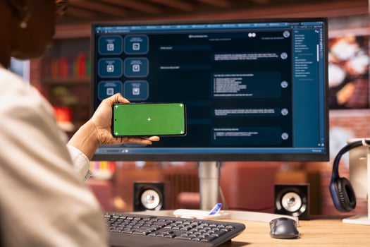 Woman using mockup smartphone to look at tutorials on AI chatbots in home office. Person holding green screen phone to look at visual guides on artificial intelligence LLMs photo