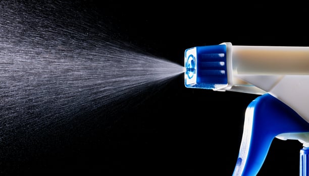 High-detail Close-Up of a Spray Nozzle Releasing Mist Against a Black Background Creating a Dynamic Visual Effect photo