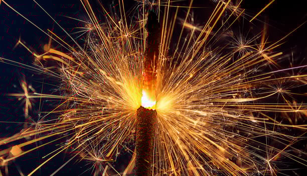 Sparkler Creates Dazzling Display of Light During Night Celebration Amidst Dark Sky photo