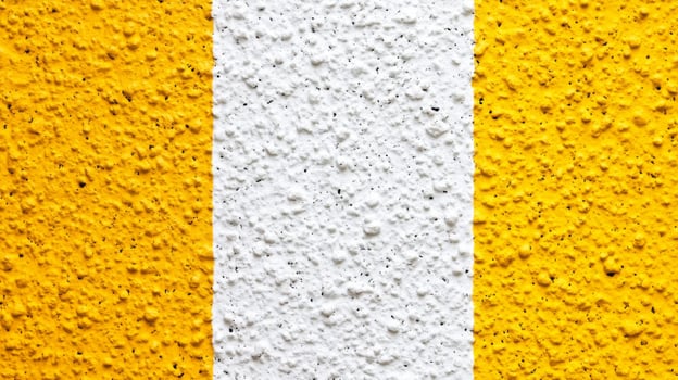 Textured Yellow and White Painted Wall Surface photo
