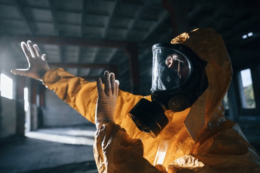 Light from nuclear explosion. Man, dressed ,in chemical protection suit in the ruins of the post apocalyptic building photo