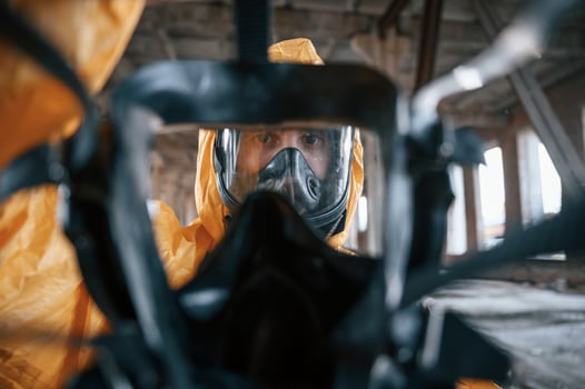 View ,through the respirator. Man dressed in chemical protection suit in the ruins of the post apocalyptic building photo