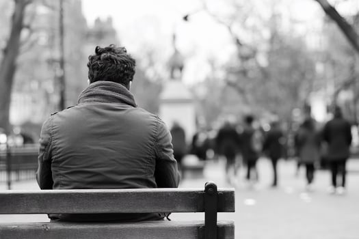 A man sitting on a bench in a park photo