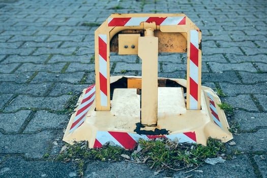 Traffic barrier on a sidewalk in an urban area, indicating road work and safety precautions during daytime hours photo