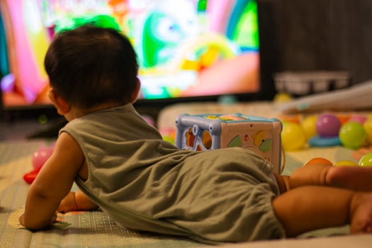 Baby In Bodysuit Is Crawling On A Soft Mat photo