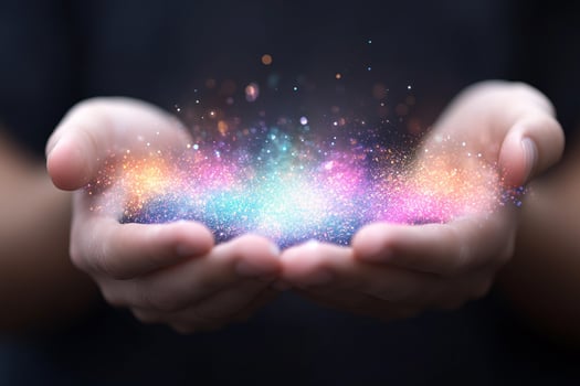 Hands holding colorful glowing particles photo