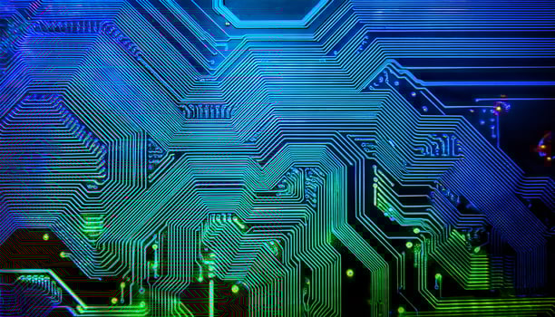 Intricate Circuitry Design Showcasing Vibrant Blue and Green Patterns on a Computer Chip photo