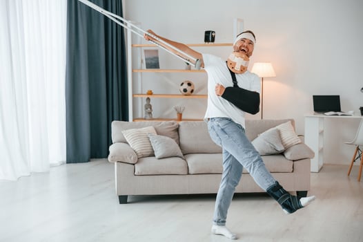 Having, fun, dancing. .Man with crutches is at home indoors. Having injuries photo
