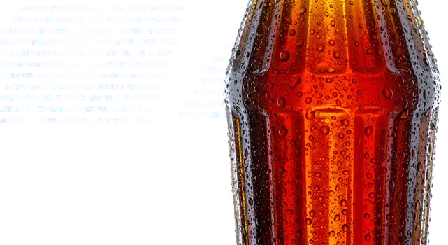 Refreshing Soda Bottle with Water Droplets Isolated on White Background photo