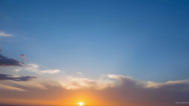 Beautiful Sunset Over Horizon with Soft Clouds and Clear Sky photo