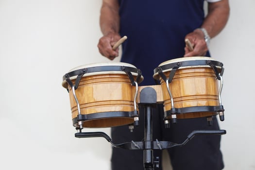 Man is beating the bongo drums. Concept, musical percussion instrument for rhythm of music to make more fun for performing or dancing. Beat drum with rhythm along music and songs. photo
