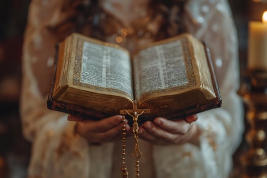Woman holding open bible and rosary with crucifix in church photo