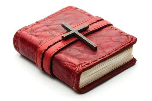 Red leather bound book with wooden cross isolated on white background photo