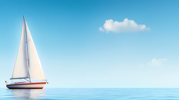 A serene sailboat gliding across calm waters under a clear blue sky with distant clouds photo