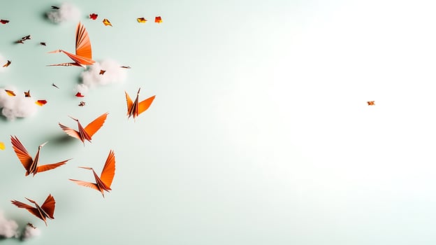 A serene scene of orange paper cranes flying through a light blue sky with soft clouds photo