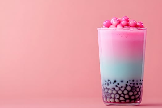 Pink and blue bubble tea with tapioca pearls on pink background photo