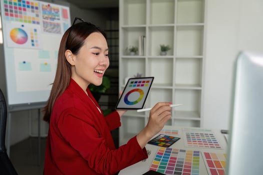 Color Exploration and Digital Design. A designer engaged with a tablet and color palette. photo