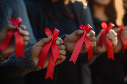 People holding red ribbons showing support for aids awareness photo