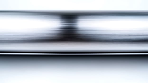 Abstract metallic surface with blurred reflections creating a sense of motion and depth photo