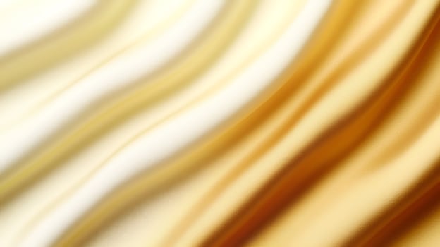 Abstract silk fabric in soft golden and cream tones flowing elegantly, creating a luxurious backdrop photo