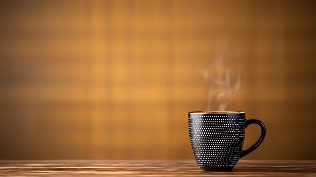 Black textured mug with steam against a warm, blurred background, evoking a cozy atmosphere photo