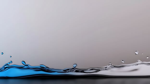 Close-up of a dynamic water splash with blue highlights against a smooth gray background photo