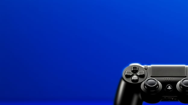 Close-up of a gaming controller on a vibrant blue background, showcasing modern technology in leisure photo