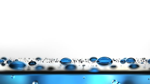 Close-up of shimmering water droplets on a smooth surface with a blurred background photo