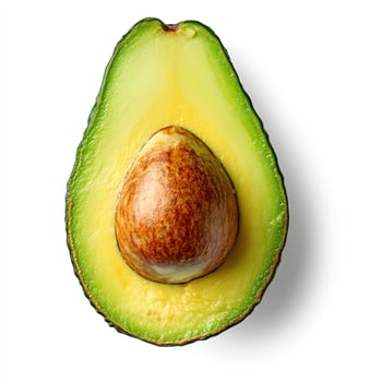 Fresh Avocado Half with Seed Shows Creamy Green and Yellow Flesh photo