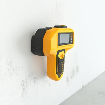 Yellow and Black Stud Finder Mounted on Wall photo