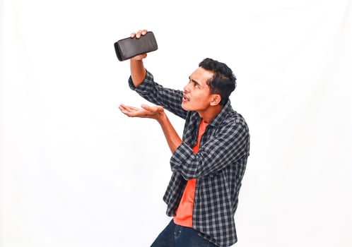 Young Man Expressing Frustration With Empty Wallet photo