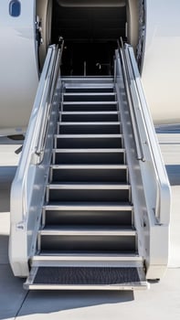 Flight steps leading to a private jet at a modern airport terminal photo