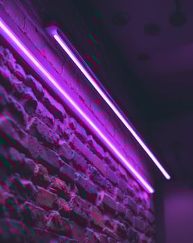 Purple Neon Lights on Brick Wall Background photo