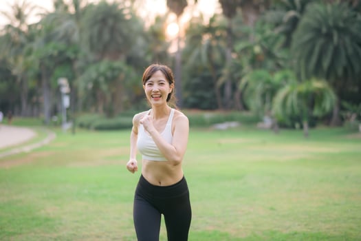 Asian woman running in the park photo
