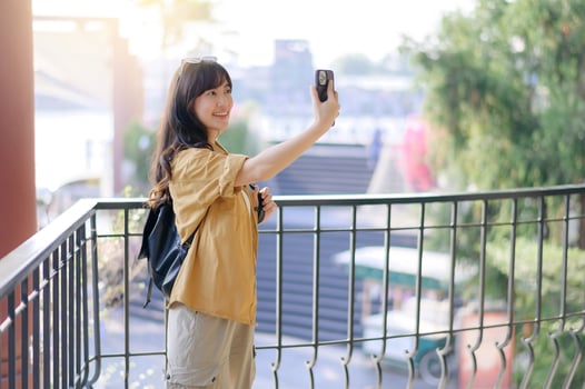 Traveler young asian woman in her 30s navigates Bangkok's vibrant streets. Let her journey inspire your own urban adventure. photo