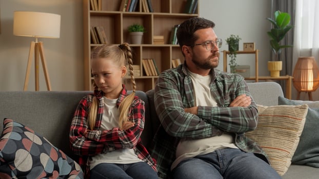 Frustrated Caucasian parent dad male talking family guy daughter arguing at home angry child crossing arms father kid turning away little girl man avoid each other trouble psychology conflict indoors photo