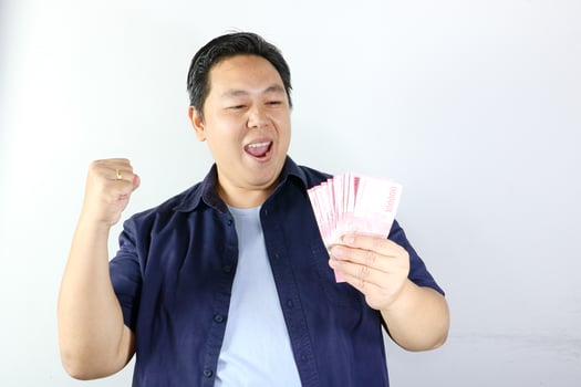 Asian man holding money and smiling photo