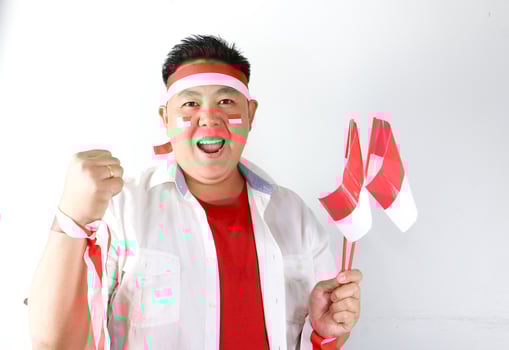 A man with a red and white face paint and a red and white flag photo