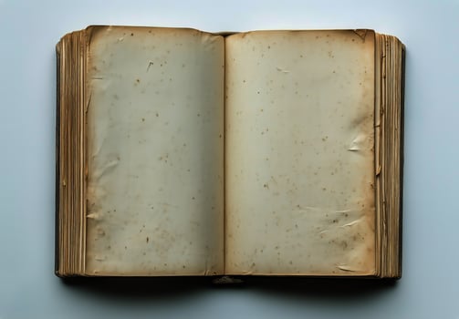 Old Open Book With Blank Pages and Worn Edges Resting on a Flat Surface photo