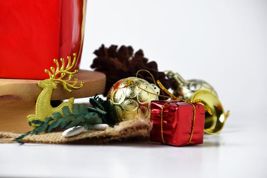 A close-up of festive Christmas decorations featuring a gold reindeer photo