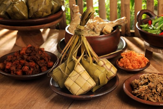 Ketupat Lebaran and Various Side Dish on the Table. Eid al Fitr Menu photo