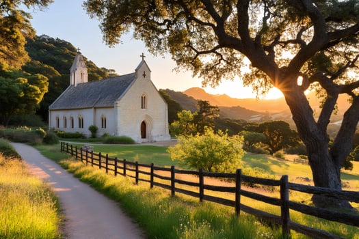 Sun shining through oak tree next to small church at sunset photo