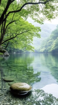 Crystal clear water reflecting lush green trees in a peaceful mountain lake photo