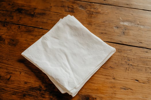 White folded cloth on wooden table photo