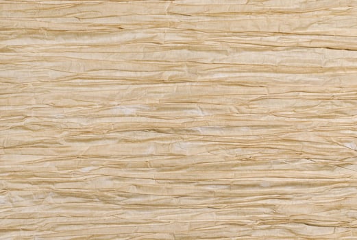 Crumpled light brown paper texture photo