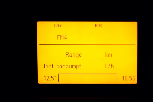 old car trip computer screen with radio and fuel consumption indicator photo